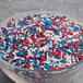 A bowl of red, white, and blue sprinkles.