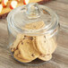An Anchor Hocking glass jar with cookies inside and a lid.