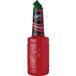 A bottle of Finest Call Premium Watermelon Puree Mix with a red liquid inside and a green lid.