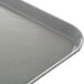 A close up of a Dinex Glasteel gray fiberglass tray.