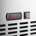 The digital clock on a stainless steel Avantco undercounter refrigerator with red numbers.