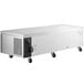An Avantco stainless steel rectangular refrigerated chef base with wheels.