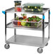 A Carlisle stainless steel utility cart with food in plastic containers.
