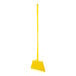 A yellow broom with a handle on a white background.