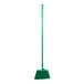 A green Carlisle commercial broom with long handle and unflagged bristles.