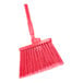 A close-up of a red Carlisle Sparta Duo-Sweep broom with a handle.