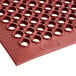 A red rubber Choice anti-fatigue floor mat with holes.