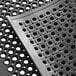 A Choice black rubber anti-fatigue floor mat with holes.
