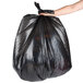 A person holding a black Berry low density trash bag.