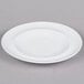 An Arcoroc white porcelain side plate with a rim on a gray surface.