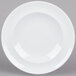 An Arcoroc white porcelain side plate with a white rim.