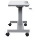 A light gray Luxor standing desk with a crank adjustable height and gray steel frame.
