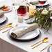 A table set with American Metalcraft white melamine plates and cutlery.