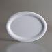 An American Metalcraft white oval melamine platter on a gray background.