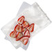 A plastic bag with strawberries inside, sealed with a Breville Commercial 6" x 10" vacuum bag.