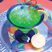 A Hoshizaki water cooled ice machine with flake ice in a glass of green liquid with straws and lemon.