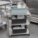 A Vollrath stainless steel utility cart with dishes on it.