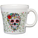 A white Fiesta tapered mug with a colorful skull and vine design.
