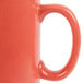 A close up of a Tuxton Cinnebar coffee mug with a handle on a white background.