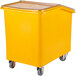A yellow Cambro soak and brine bucket with wheels and a clear flip top lid.