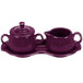 A purple ceramic tray with a sugar bowl and a creamer on it.