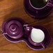 A purple tea set with a Fiesta creamer and cup of coffee on a tray.