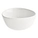 An Acopa Nova cream white stoneware bowl with a curved edge on a white background.