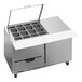 A Beverage-Air stainless steel refrigerated sandwich prep table with clear lids open on two drawers.