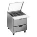 A Beverage-Air stainless steel refrigerated sandwich prep table with two drawers and a clear lid open.