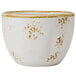A white Tuxton china bouillon cup with brown speckles.