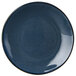 A close-up of a Tuxton Artisan Night Sky China Plate with a blue center and black rim.