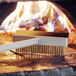 An American Metalcraft pizza oven brush with a wooden handle and scraper.