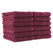 A stack of Monarch Brands burgundy hand towels.