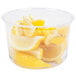 A clear Fabri-Kal deli container filled with lemon slices.