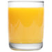 An Arcoroc tumbler filled with orange juice on a white and yellow surface.