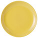 A yellow Tuxton china plate with a white background.