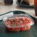 A Dart ClearPac plastic container of salsa on a tray.