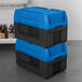 A stack of blue and black Metro Mightylite food pan carriers.