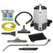 A ProTeam backpack vacuum cleaner with various tools.