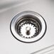 A close-up of the drain on an Advance Tabco hands-free hand sink.