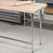 An Advance Tabco wood top work table with a rolling pin on it.
