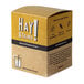A box of HAY! Natural Wheat cocktail straws with yellow and white text on a yellow sign.