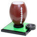 A football shaped drink holder with a football on top.