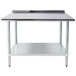 An Advance Tabco stainless steel work table with a shelf.