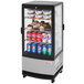 A Turbo Air countertop display refrigerator with drinks and snacks inside.