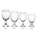 A row of Acopa customizable clear glass goblets with stems.