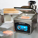 A machine with a tray of hot dogs in ARY VacMaster Cook-In Chamber Vacuum Packaging Bags.