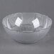 A Carlisle clear polycarbonate bowl with a curved edge.