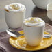 A white bowl of UPOURIA Fat Free French Vanilla Cappuccino with whipped cream and a spoon.