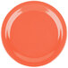 A Carlisle Dallas Ware sunset orange melamine plate on a table.